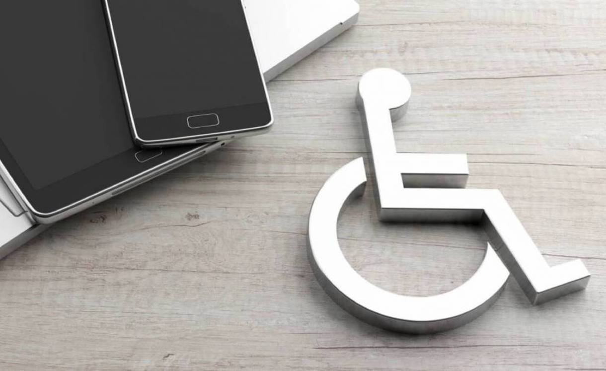 |Laptop and mobile devices with wheelchair icon on wooded surface